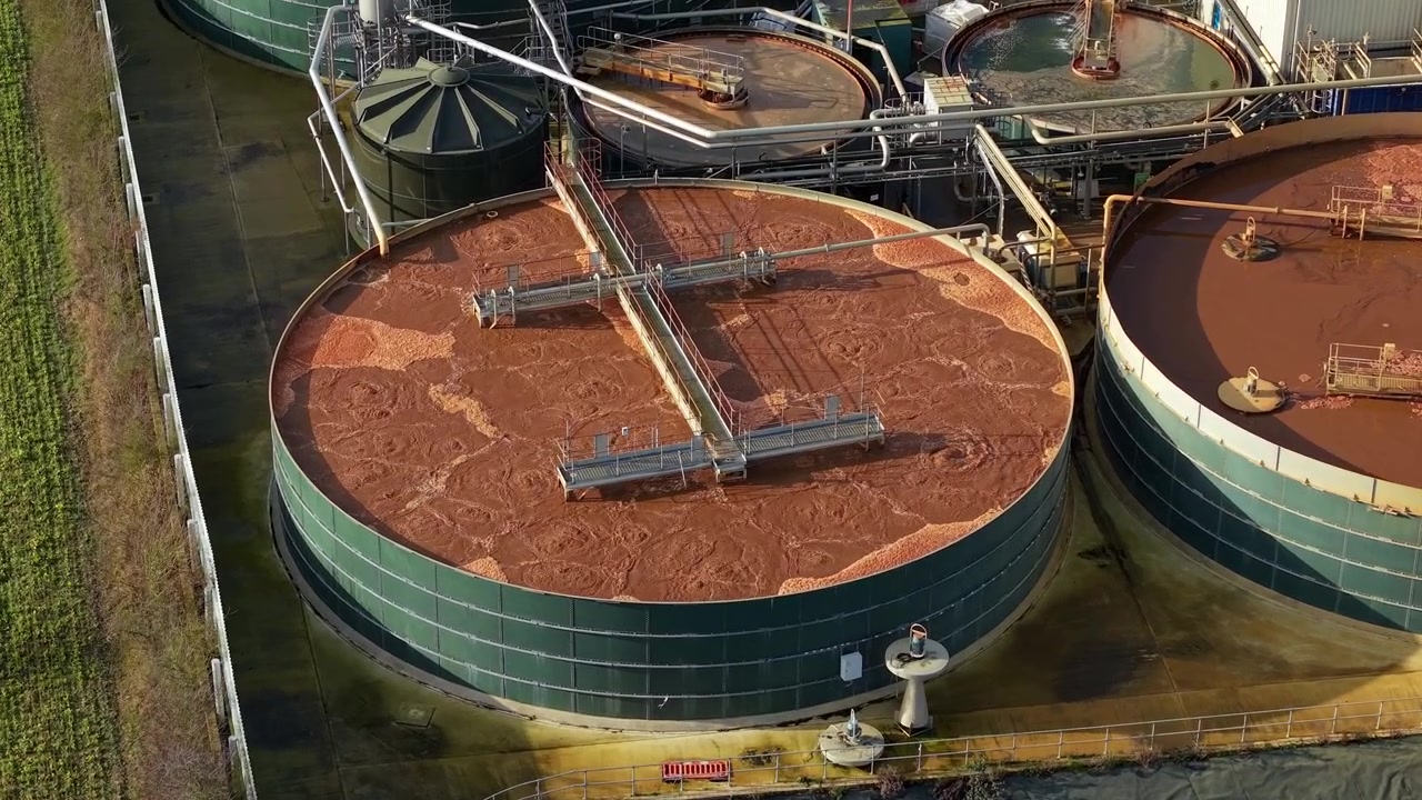 Aerial drone view of a large industrial factory with liquid storage silos containing processing water in Lincolnshire UK