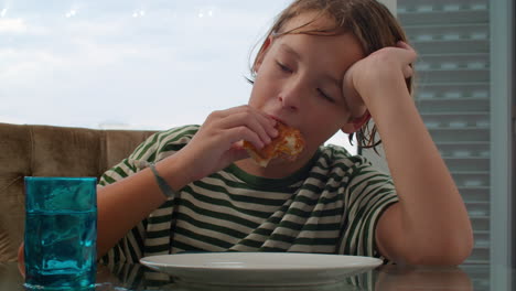 teenage boy eating burger and playing game