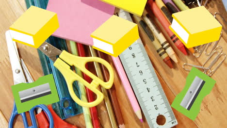 a variety of school supplies are scattered on a wooden surface