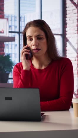 vertical video displeased angry person yelling on the telephone line in her loft