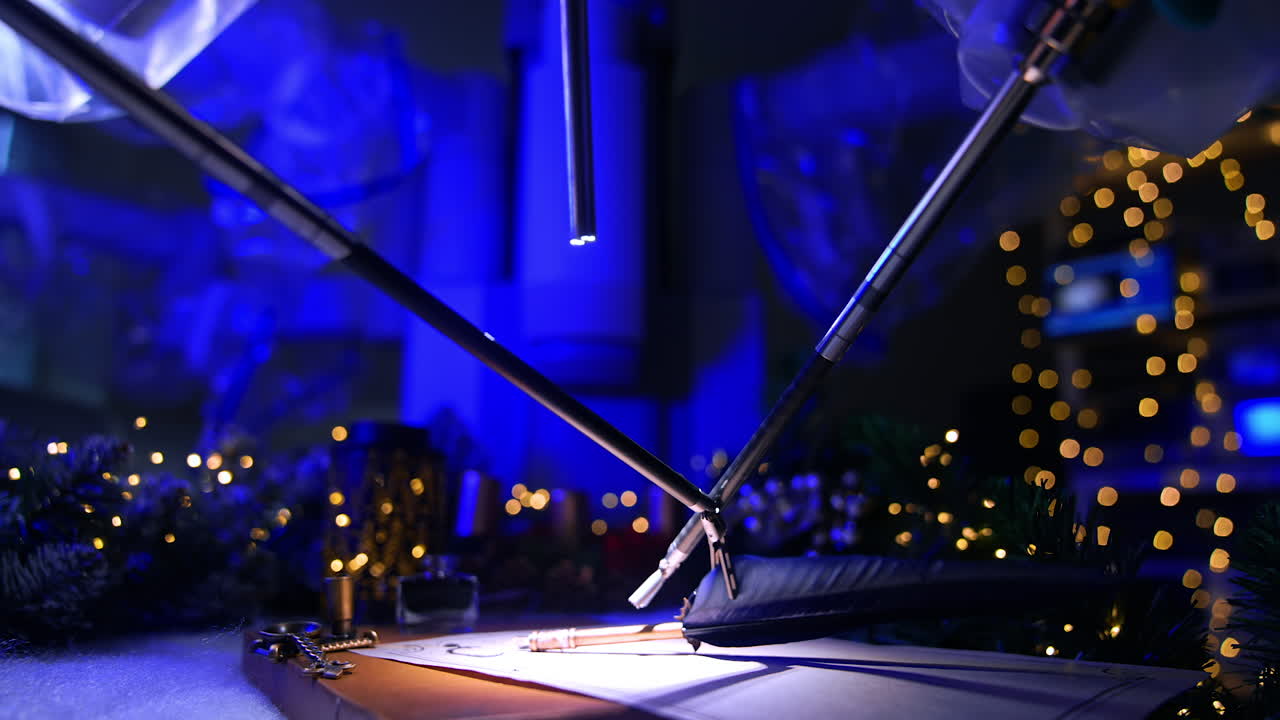 Robotic arms for microsurgery take the old-fashioned writing pen. Christmas garlands and lights at backdrop in dark surgical room.