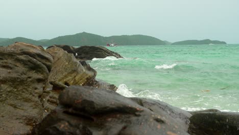 Phi-Phi-island-Phuket-Thailand-fisherman-boat-cliff-and-waves-panning-shot