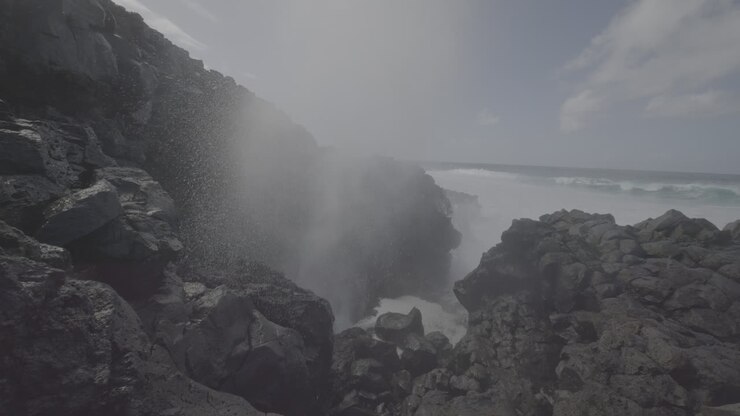 Powerful Waves Crashing Against Volcanic Coastline