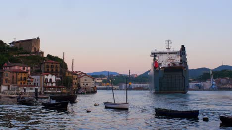 big cargo ship, vehicle carrier entering the bay during the golden hour