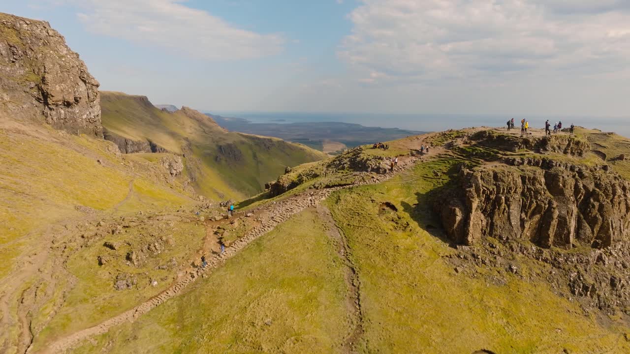 Aerial drone footage of the dramatic mountain landscapes on the Isle of Skye, Scotland. Sweeping panoramic views of majestic peaks, green valleys, and wild nature. Old man of Storr