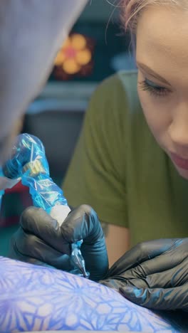 tattoo artist working on a client
