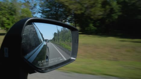 view of the passenger mirror in a moving car