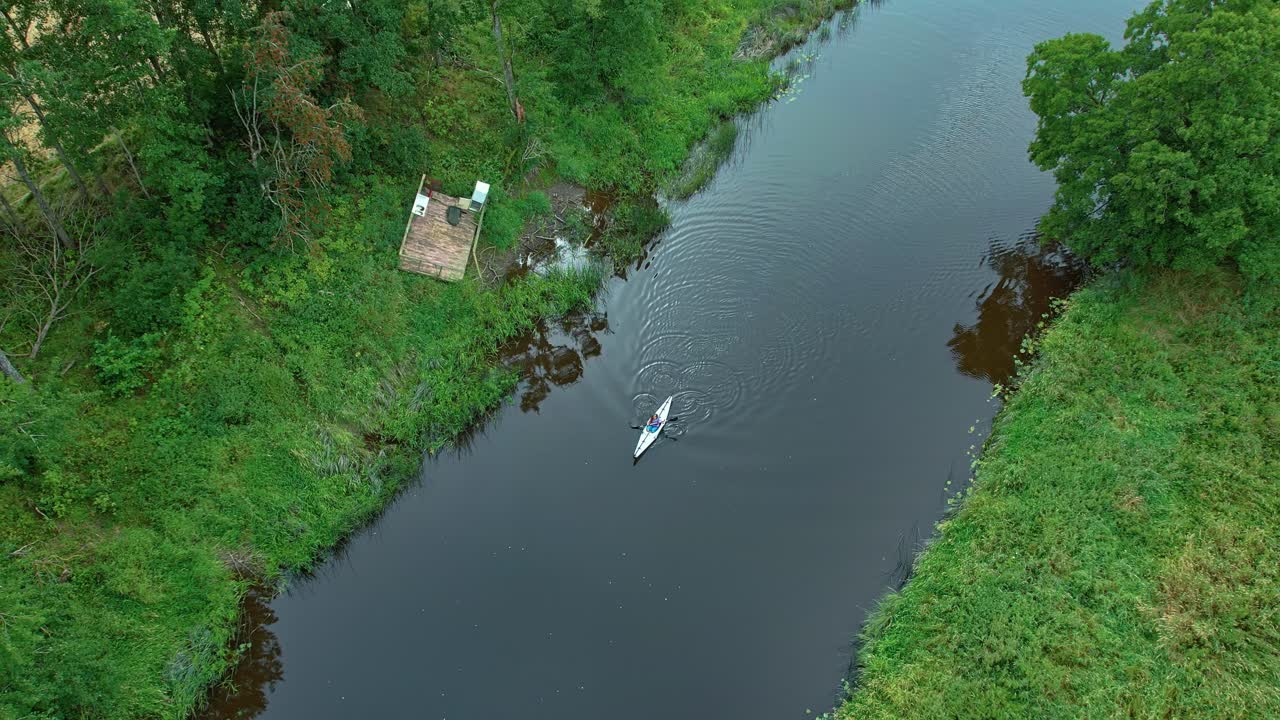 Ascending Drone Captures Solo Kayaker Paddling on Dalbergsan River, Asebro, Dalsland
