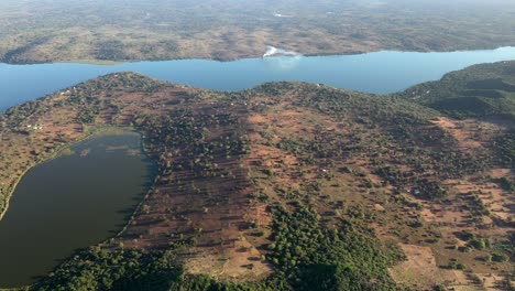 high altitude forward flying shot of inhampavala lake in chindeguele mozambique during golden hour sunrise