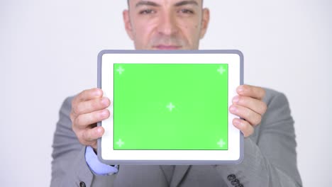 businessman making presentation with green screen tablet
