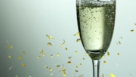 animación de confeti de oro cayendo sobre un vaso de champán