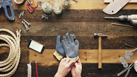 top view artisan craftsman hands using smartphone touchscreen viewing building plans from above - red epic dragon