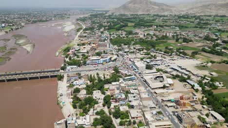 river, city, greenery, and hills