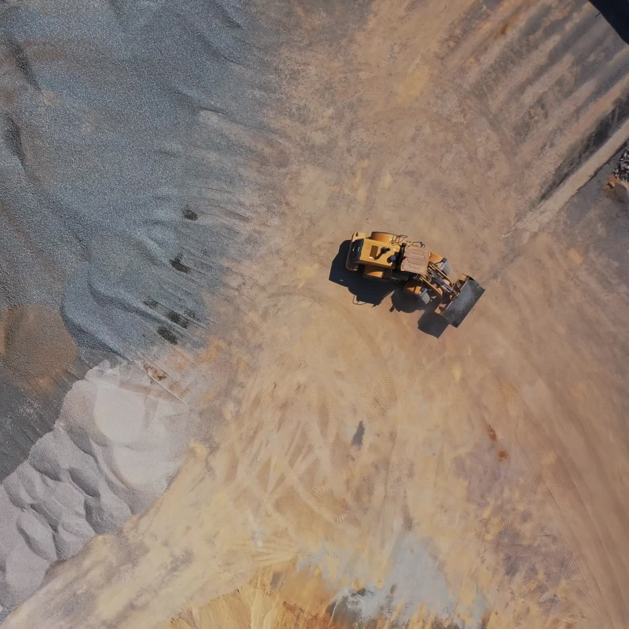 Excavator working on sandy surface