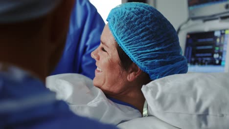 close-up of man comforting pregnant woman during labor in operation theater at hospital