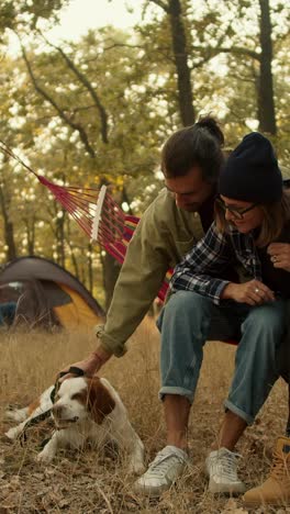 couple camping with dog
