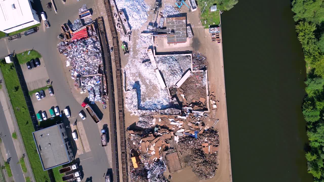 scrap metal recycling center managing waste and loading trucks, Hennigsdorf, Germany. Magic aerial view flight vertical bird's eye view overflight flyover drone