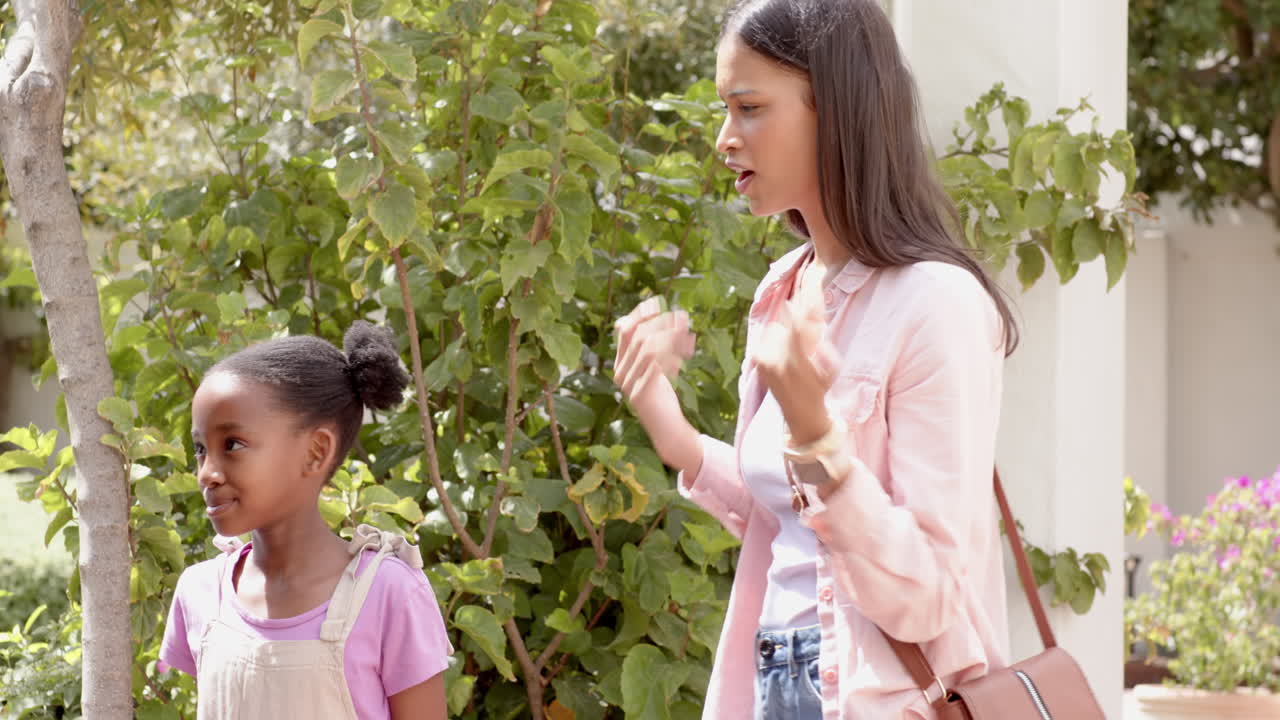 In garden, diverse family bonding and smiling during in garden time together