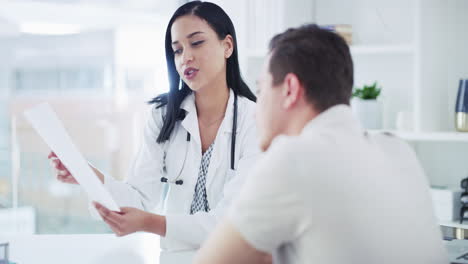 a-young-woman-going-over-paperwork-with-a-patient