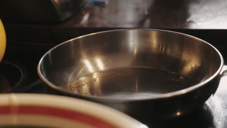 Canada---Flipping-Cooked-Pancake-In-A-Stainless-Pan-Before-Removing-From-Heat---Closeup-Shot