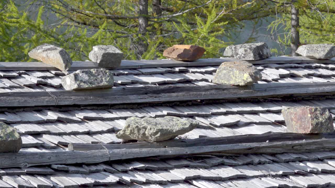 Stones lie on a shingle roof and hold the shingles in place with their weight