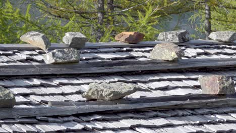 stones lie on a shingle roof and hold the shingles in place with their weight