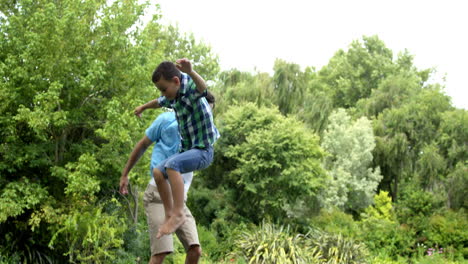 Happy-father-and-son-playing-on-the-trampoline-