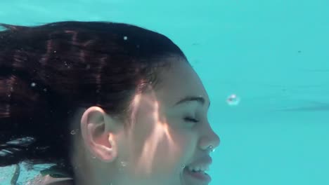 Underwater-view-of-pretty-woman-swimming-