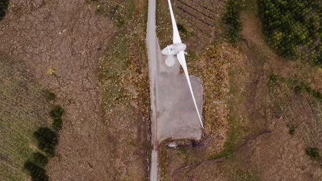 drone shot of a single track road near a wind turbine on the hebrides