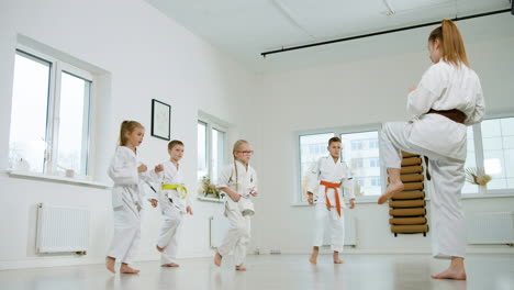 kids in white kimono in martial arts class