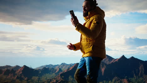 careless hiker tries to make a phone call on the mountain top and falling off
