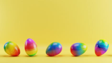 multicolored easter eggs rolling on a yellow background. loop animation