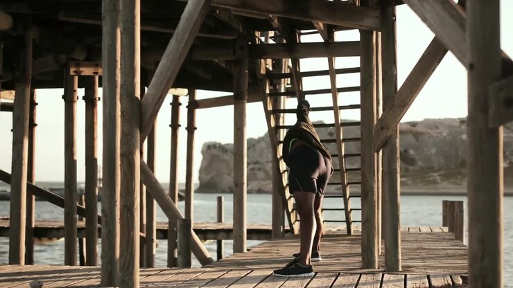 Man performing stretching exercising on the promenade