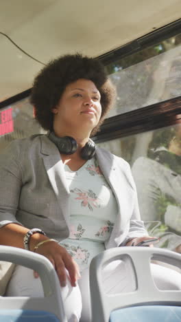 vertical video of plus size biracial woman in bus