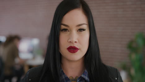 portrait serious young woman entrepreneur in office workspace background looking at camera wearing red lipstick independent caucasian female slow motion