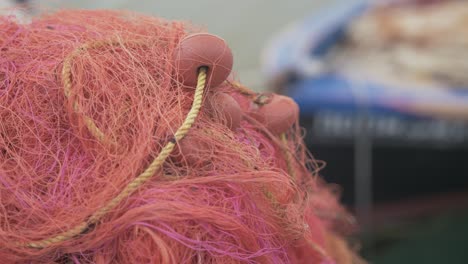 Fishing-nets-on-pier-shallow-depth-of-field-boat-in-background-SLOW-MOTION