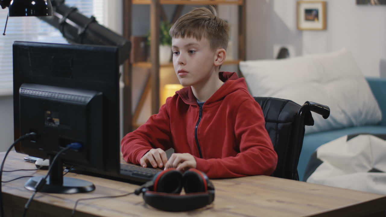 Boy in Wheelchair Using Computer