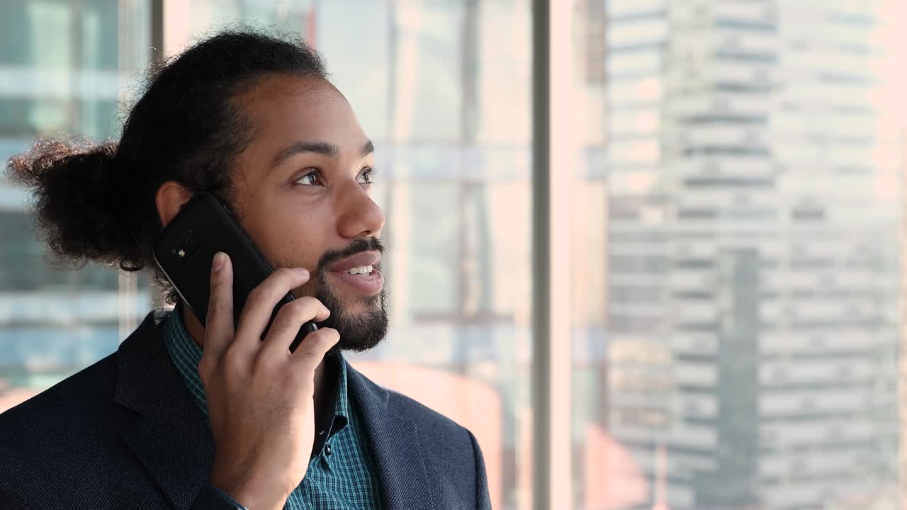 Confident African businessman in suit talk to client on cellphone