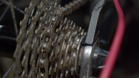 close up of bicycle rear sprocket as bike chain slowly spins wheel