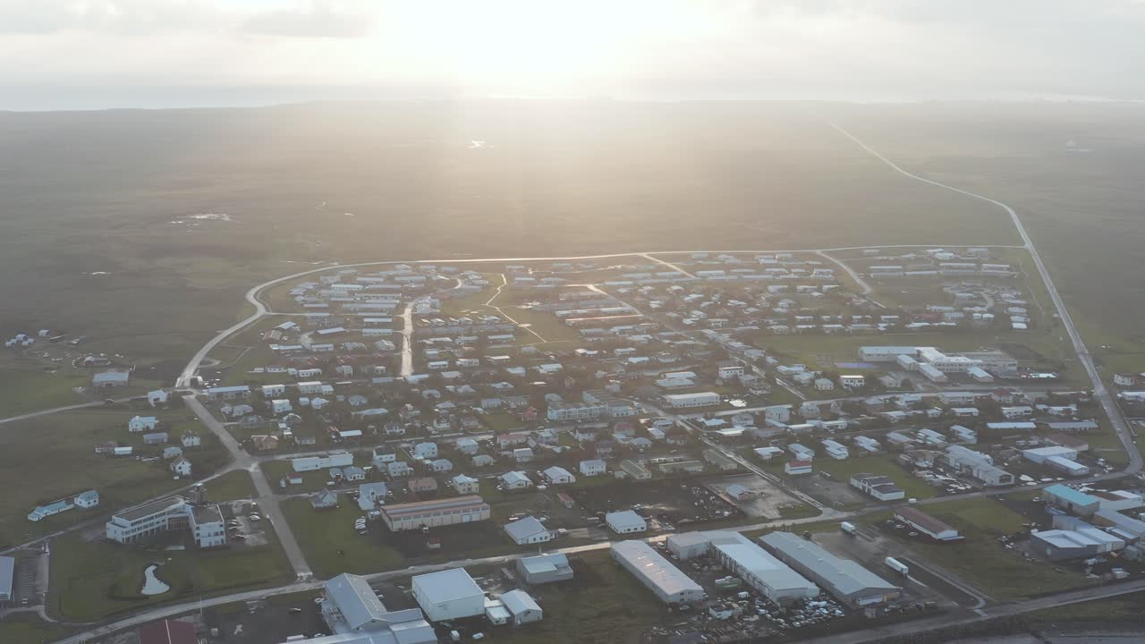 Cittadina di pescatori costiera Sandgerði durante una luminosa alba nell'ora d'oro, ripresa aerea