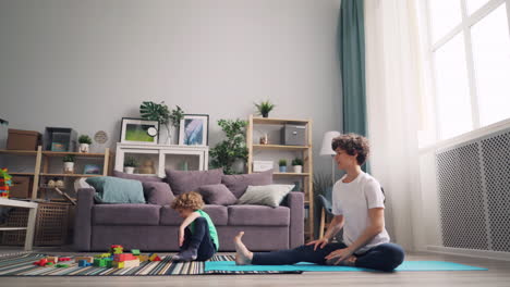 mother and child doing yoga at home