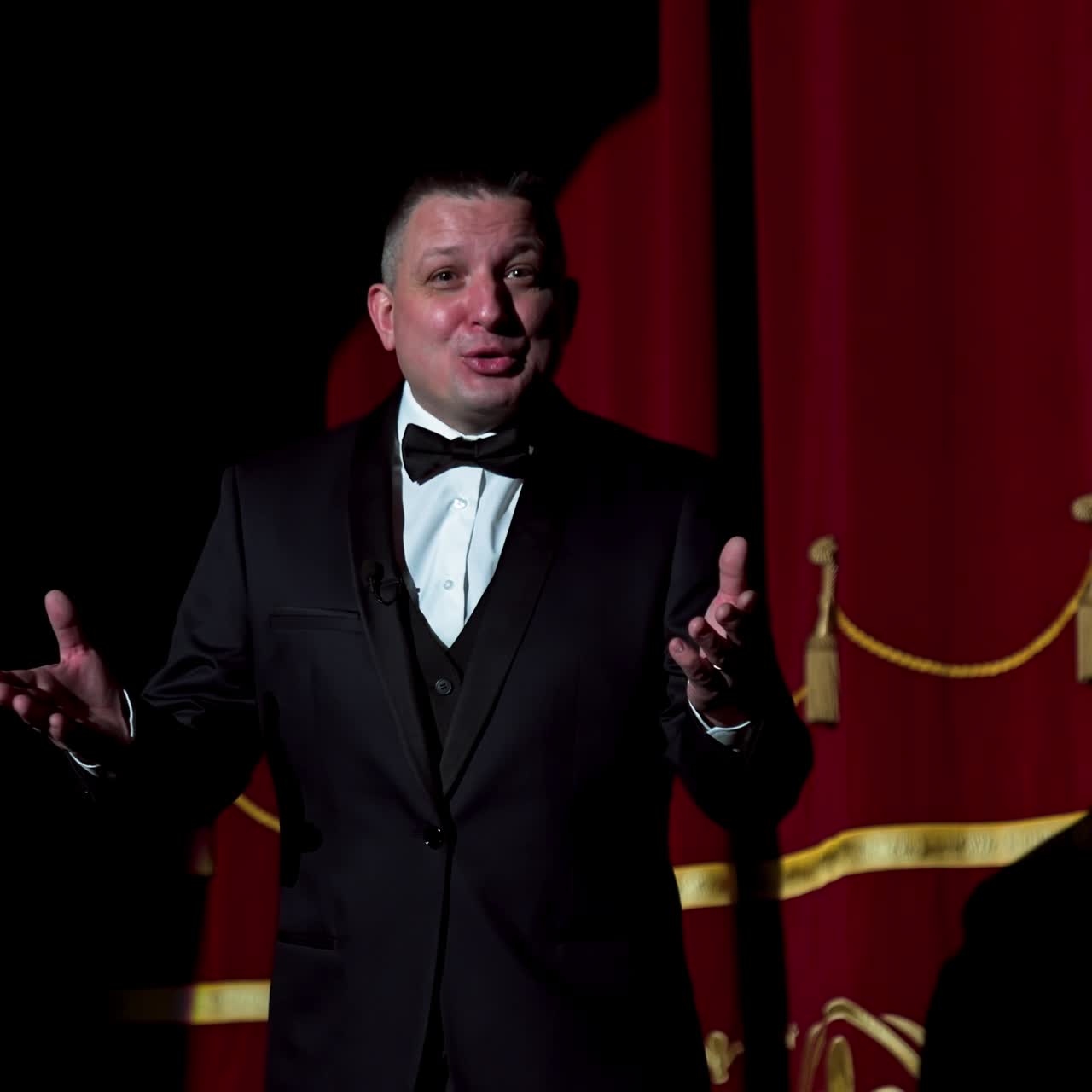 Actor on a stage. Adult man talks to the public in microphone or sings songs. Theater concept