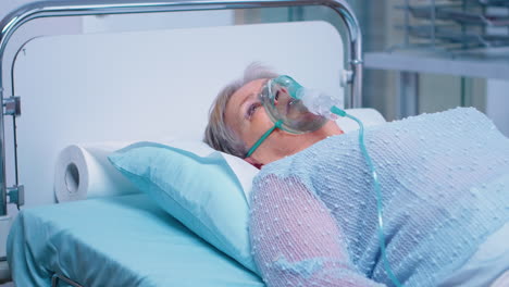 retired old woman breathing with oxygen mask