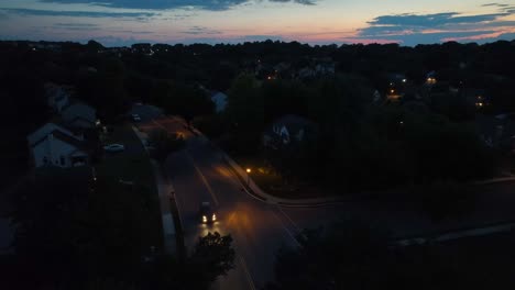 car driving on american neighborhood road at night