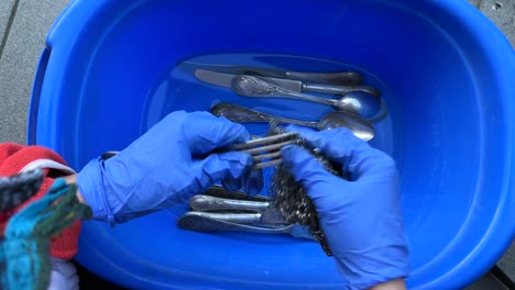 washing silverware in a bowl