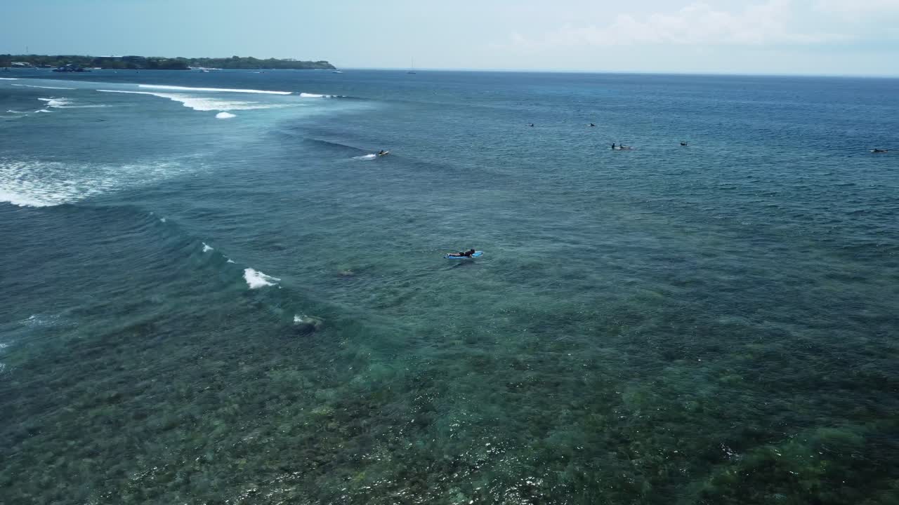 Surfer paddles over wave about to break heading back out to line up