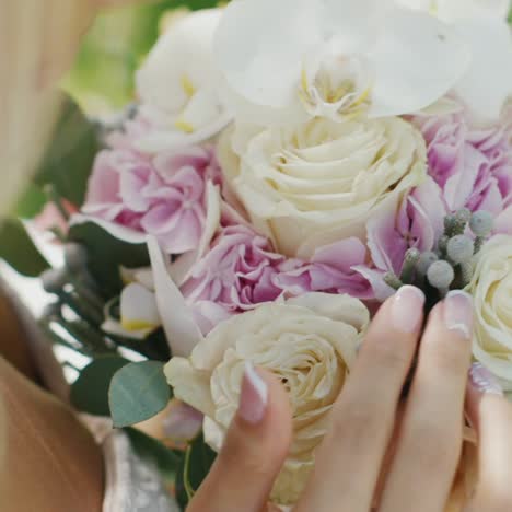 blonde bride is considering her bridal bouquet