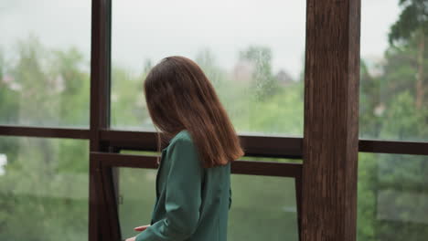 pensive businesswoman walks along glass terrace. trader broken by unexpected stock market crash suffers in office. difficult situation in company