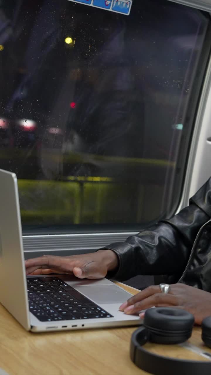 Man working on laptop while traveling by train