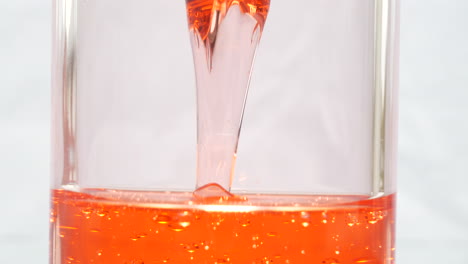 close up of viscous red liquid in hourglass